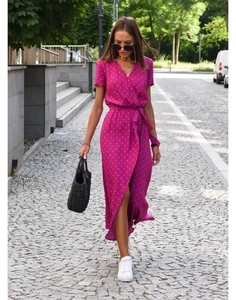 Detail of purple wrap midi dress featuring red polka dot prints and a V-neckline waist tie
