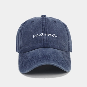 Detail of white cursive mama embroidery on vintage washed navy denim baseball cap