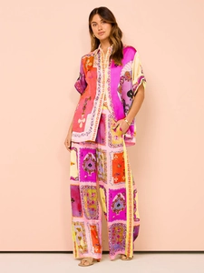 Fashionable summer lounge set with vibrant poker print shirt and wide-leg trousers
