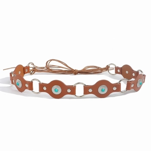 Detail of bohemian brown leather belt with turquoise stones and silver metal rings