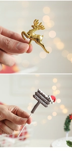 Close-up of golden reindeer and Merry Christmas cake topper decorations for festive events