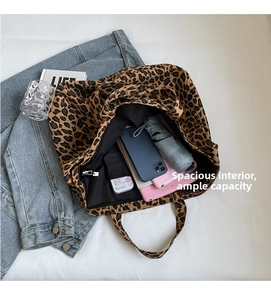 Spacious interior of leopard print canvas tote bag with internal zipper pocket