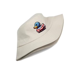 Detail of beige cotton bucket hat featuring a cartoon duck with flag pattern print