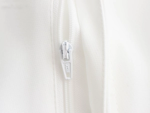 Detailed macro view of high-quality white metal zipper and smooth fabric texture