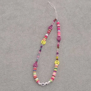 Detailed close-up of colorful beaded phone lanyard with LOVE letter beads and smiley faces