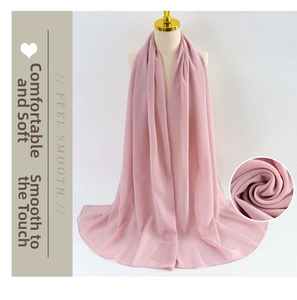 Detail of light pink pearl chiffon scarf showing soft texture and fine edge stitching