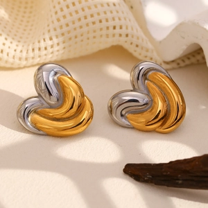 Detailed view of two-tone gold and silver heart studs with sleek intertwined design