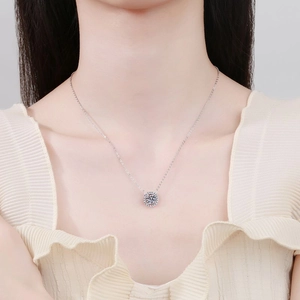 Classic moissanite necklace in 925 silver with a round pendant on a woman neck