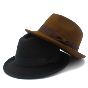 Detail of classic felt fedora hats in black and dark brown with grosgrain ribbon bow
