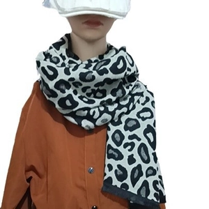 Chic black and white leopard print thick cashmere scarf styled on a model for winter