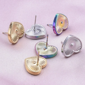 Detailed macro view showing radiant back texture of heart-shaped stainless steel earrings