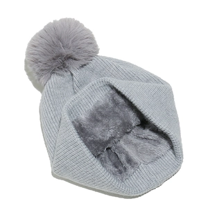 Detail of gray knit beanie with thick fleece lining and soft faux fur pompom for winter
