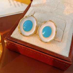 Macro detail of vintage oval stud earrings with enamel oil drip and S925 silver needles