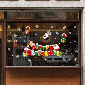 Christmas window decals with Santa Claus and reindeer on a festive shop window display