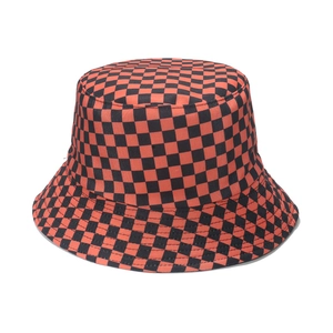 Detailed close-up of the red and black checkered pattern on a canvas fisherman hat