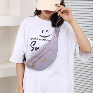 Purple nylon crossbody waist bag with multi-zipper compartments worn by a model