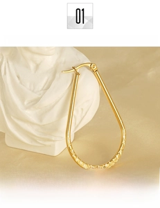 Macro detail showing the polished 18K gold plated surface of teardrop earrings