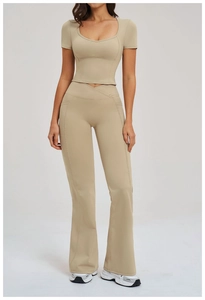 Detail of high waist yoga pants with V-shaped crossover waistband and side pockets