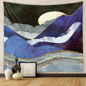 Modern mountain tapestry detail with golden sand lines and full moon on a gray wall