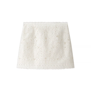 Elegant white lace mini skirt with intricate floral embroidery and scalloped hem details