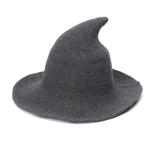 Close-up of dark grey knitted witch hat showing thick yarn texture and pointed design