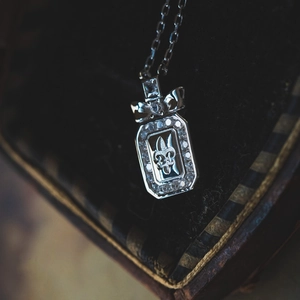 S925 sterling silver necklace with fleur-de-lis pendant and sparkling bow details