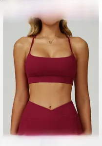 Detail of cross V-waist yoga pants and U-neck sports bra in deep burgundy fabric