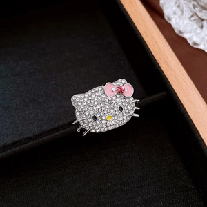 Macro shot of Hello Kitty ring with white crystals and pink enamel bow detail
