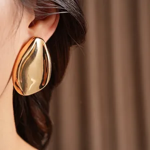 Polished gold oversized teardrop earrings in a minimalist leaf-inspired folded design