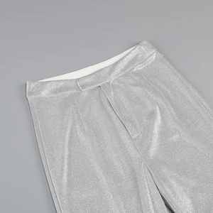 Detailed close-up of metallic silver sequin pants showing waistband and fabric texture