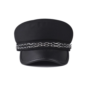 Detail of black military cap with silver chain decoration and faux leather brim