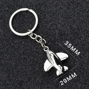 Silver fighter jet keychain dimensions detail showing 35mm length and 29mm wingspan