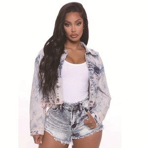 Detailed view of bleach wash denim set with frayed edges and metal buttons texture