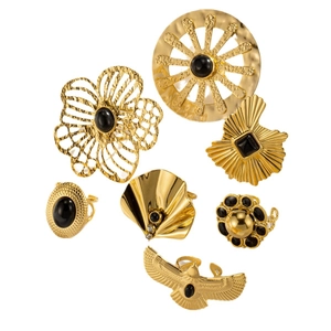 Detailed set of seven vintage gold-finish rings with black onyx-style stones and engravings