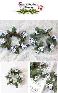 Detail of Christmas wreath with white berries and green leaves on brown vine base
