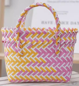 Detailed close-up of the colorful woven texture on the pink and yellow handbag