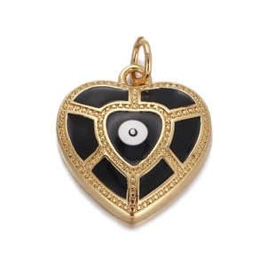 Macro view of a gold heart pendant featuring a black enamel evil eye and zircon inlay