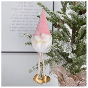 Pink velvet Santa gnome ornament hanging on a Christmas tree branch with pine cones