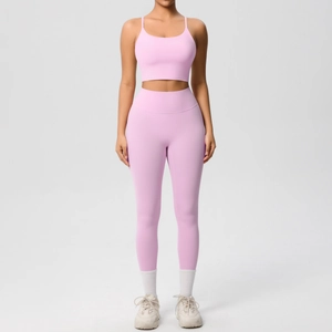 Front view of a light pink yoga set with spaghetti strap top and high-waist leggings