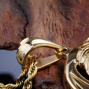 Macro close-up of the twisted rope chain and gold-plated clasp on a lion pendant