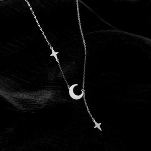 Detail of silver titanium steel Y-necklace featuring crescent moon and star pendants