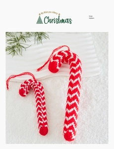 Macro shot of red and white knitted candy cane ornaments with herringbone weave detail