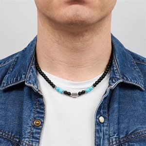 Detail of men's beaded necklace featuring black obsidian and turquoise stones on a model