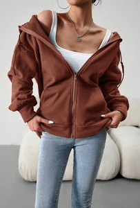 Detail of a brown zip-up fleece hoodie featuring adjustable drawstring sleeves and side pockets