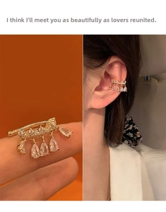 Detail of 14k gold-plated ear cuff featuring sparkling pear-shaped zircon stones