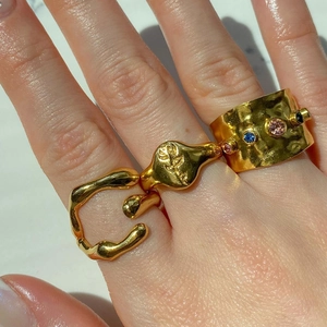 Golden irregular geometric rings with colorful gemstones worn on hand by models