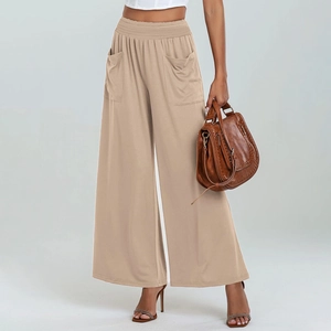 Detail of high waisted wide leg trousers in khaki with elastic waist and side pockets