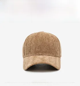 Detailed front view of brown herringbone tweed baseball cap showing premium fabric texture