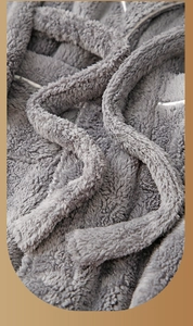 Close-up of thick dark grey plush fleece fabric showing soft and warm texture
