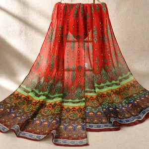 Detail of red chiffon scarf with bohemian geometric prints and sheer texture